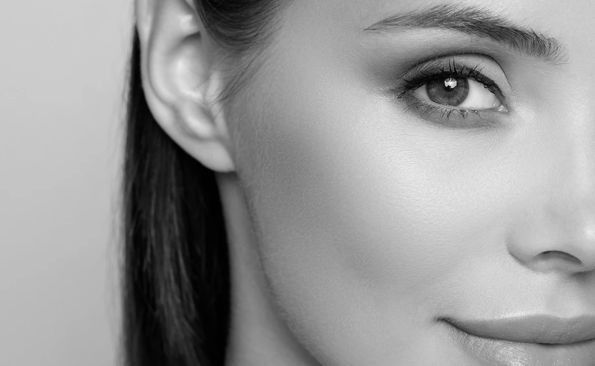 woman with flawless skin up close in black and white