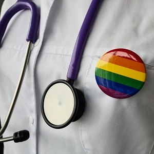 Doctor wearing LGBTQIA rainbow pin